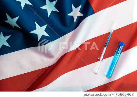Vaccine vial. Medical syringe with needle for protection flu virus and coronavirus. Covid inoculation usa flag of america. Close up vaccine vial dose flu shot drug needle syringe. 73603407