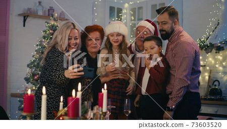 Happy family celebrating relatives in video chat on Christmas 73603520