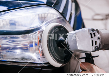 polishing car headlights at shallow depth of field polishing car headlights at shallow depth of field 73603948