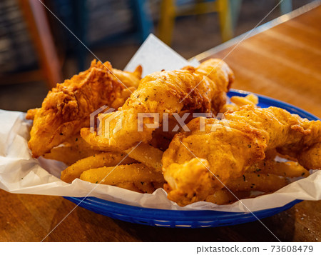 Close up shot of a plate of fish and chips Close up shot of a plate of fish and chips 73608479