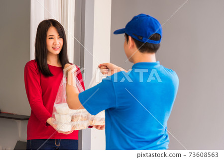 Delivery man making grocery service giving rice food boxes plastic bags to woman customer Delivery man making grocery service giving rice food boxes plastic bags to woman customer 73608563