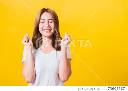 woman teen standing wear t-shirt makes raised fists up celebrating her success 73608587