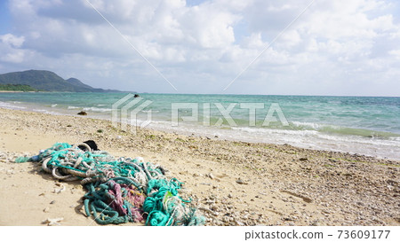 Marine plastic garbage rope on the beach 73609177
