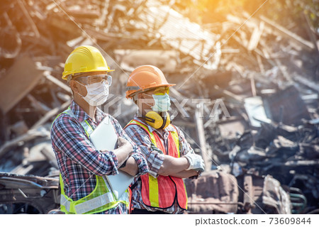 Professional Industrial Mechanical Engineer with Factory Worker while Using Laptop Computer 73609844