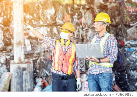 Professional Industrial Mechanical Engineer with Factory Worker while Using Laptop Computer Professional Industrial Mechanical Engineer with Factory Worker while Using Laptop Computer 73609853