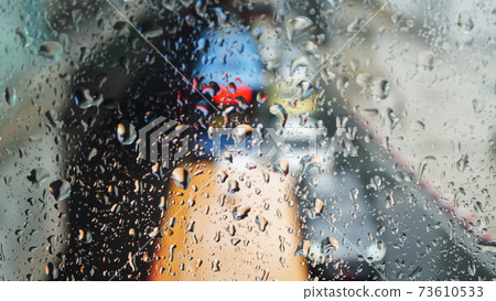 Rain drops at glass window Rain drops at glass window 73610533