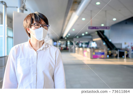Asian man wearing mask at skytrain station Asian man wearing mask at skytrain station 73611864
