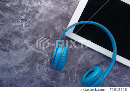 the concept of Audio book , Headphones and digital tablet on black background the concept of Audio book , Headphones and digital tablet on black background 73612528
