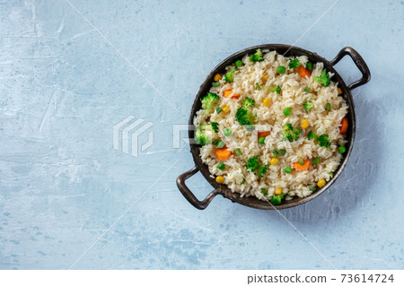 Vegan rice, stir-fried with vegetables, overhead shot Vegan rice, stir-fried with vegetables, overhead shot 73614724