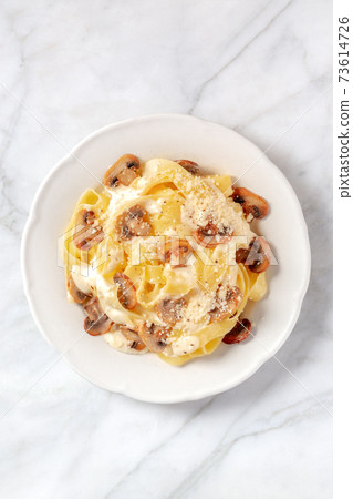 Pappardelle pasta with mushrooms, cream sauce and cheese, shot from above Pappardelle pasta with mushrooms, cream sauce and cheese, shot from above 73614726