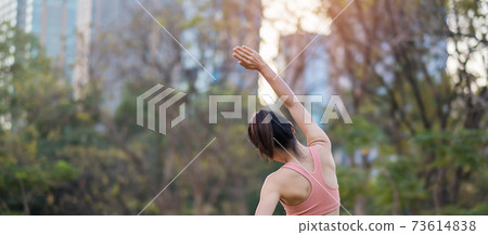 Young adult female in pink sportswear stretching muscle in the park outdoor, sport woman warm up ready for running and jogging in morning. wellness, fitness, exercise and work life balance concepts Young adult female in pink sportswear stretching muscle in the park outdoor, sport woman warm up ready for running and jogging in morning. wellness, fitness, exercise and work life balance concepts 73614838