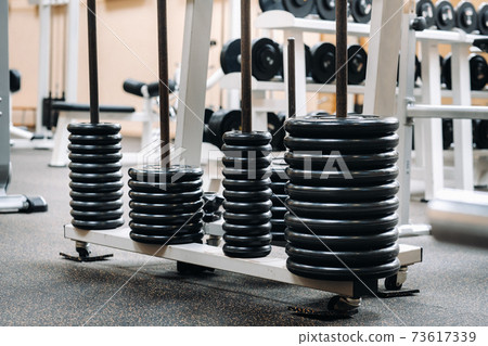 barbell discs stacked in rows in the gym barbell discs stacked in rows in the gym 73617339