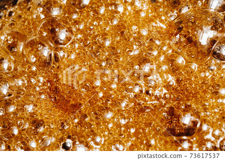Preparation of sugar candies at home.A taste of our childhood.Background, sugar bubbles Texture.Boiling caramel sugar 73617537