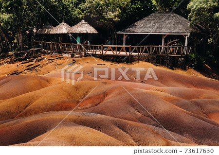 Seven colored earths in Mauritius, nature reserve, Chamarel. The green forest is behind us.Mauritius island 73617630