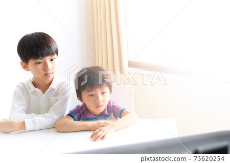 Two boys staring at the monitor screen Two boys staring at the monitor screen 73620254