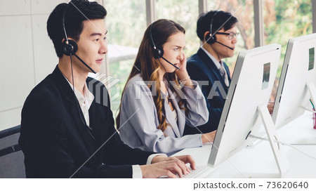 Business people wearing headset working in office 73620640
