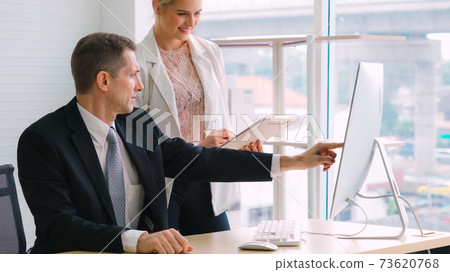 Two business people talk project strategy at office 73620768