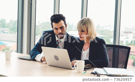 Two business people talk project strategy at office 73620957