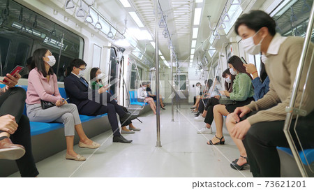 Crowd of people wearing face mask on a crowded public subway train travel 73621201