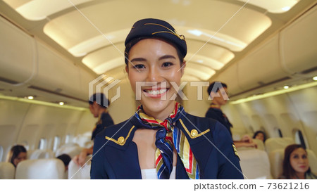 Cabin crew or air hostess working in airplane Cabin crew or air hostess working in airplane 73621216