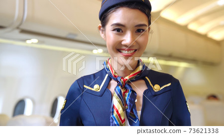 Cabin crew or air hostess working in airplane Cabin crew or air hostess working in airplane 73621338