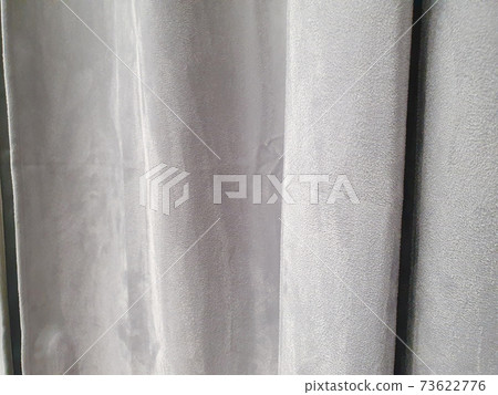 Gray polyester curtains, blackout curtains made from recycled material. Close-up Gray polyester curtains, blackout curtains made from recycled material. Close-up 73622776