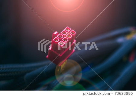 Computer power connector from power supply close-up in rays of light and glare Computer power connector from power supply close-up in rays of light and glare 73623890