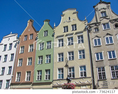 Facade of old residential house, windows., sky sunny day. Gdansk, Poland. 73624117