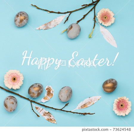 Easter Decoration with gray golden eggs, quail feathers, flowers on blue background. Happy Easter card concept, top view. Easter Decoration with gray golden eggs, quail feathers, flowers on blue background. Happy Easter card concept, top view. 73624548