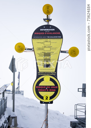 Sign indicating the risk of avalanches in the skiing area of the three valley's, Meribel, the French Alps	 73624884