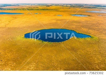 Miory District, Vitebsk Region, Belarus. The Yelnya Swamp. Upland And Transitional Bogs With Numerous Lakes. Elevated Aerial View Of Yelnya Nature Reserve Landscape. Famous Natural Landmark Miory District, Vitebsk Region, Belarus. The Yelnya Swamp. Upland And Transitional Bogs With Numerous Lakes. Elevated Aerial View Of Yelnya Nature Reserve Landscape. Famous Natural Landmark 73625302