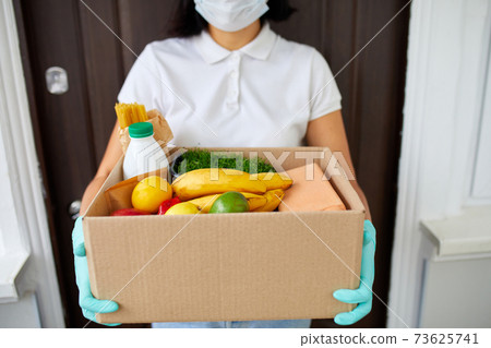 Courier with packing box with food, contactless delivery Courier with packing box with food, contactless delivery 73625741
