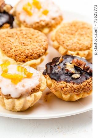 Sweet mini tart served on white plate Sweet mini tart served on white plate 73625772