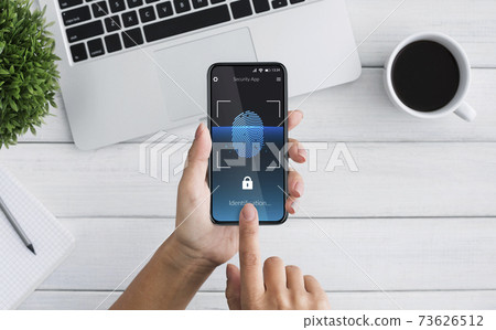 Woman Unlocking Smartphone Scanning Fingerprint For Biometric Identification Indoor, Top-View 73626512