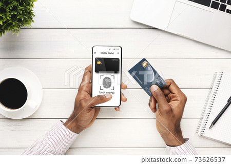 Black Man With Phone Using Mobile Wallet Application At Workplace 73626537