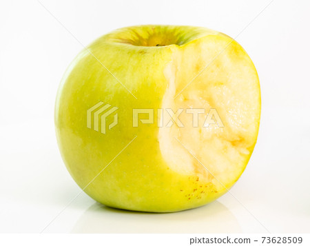 bitten yellow apple fruit on plate on white bitten yellow apple fruit on plate on white 73628509