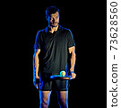 Paddle tennis player man light painting isolated black background 73628560