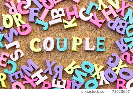 Color alphabet in word couple with another letter as frame on cork board background 73628697