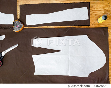 view of paper layouts of pattern on brown fabric view of paper layouts of pattern on brown fabric 73628860