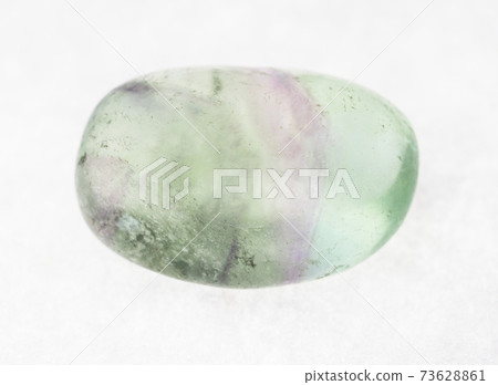 tumbled fluorite (fluorspar) gemstone on white tumbled fluorite (fluorspar) gemstone on white 73628861