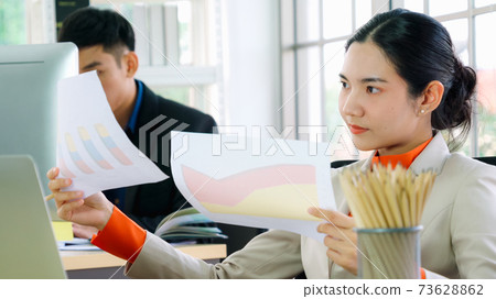 Business people working at table in modern office Business people working at table in modern office 73628862