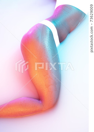 Close up female body in the milk bath with soft glowing in neon light 73629009