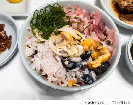 various seafood and chopped raw fishes in bowl 73629450