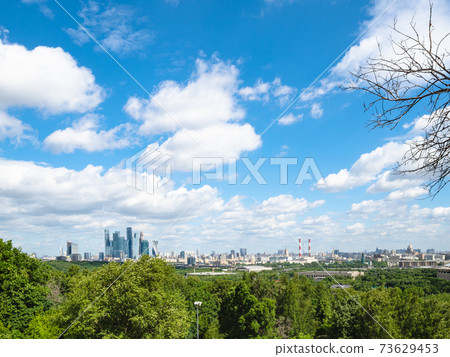 white cimulus clouds in blue sky over Moscow city white cimulus clouds in blue sky over Moscow city 73629453