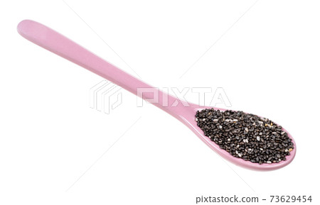 Chia seeds in ceramic spoon cutout on white 73629454