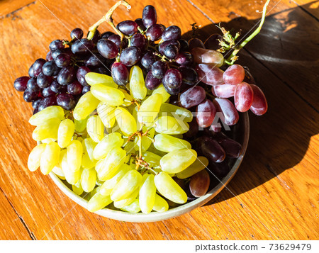crimean white ladyfinger and red grapes on plate crimean white ladyfinger and red grapes on plate 73629479