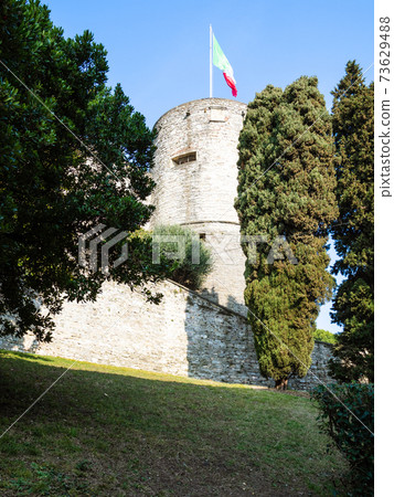 view of Rocca di Bergamo fortress with flag on top 73629488