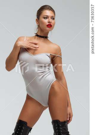 Alluring young woman in black underwear and boots 73630357