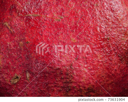 Peeled pomegranate close-up on a black background. 73631904