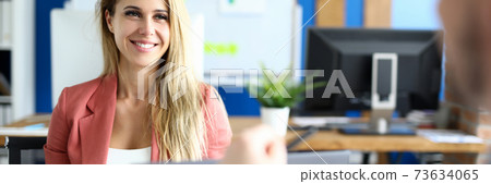 Beautiful employee sits in front of her boss 73634065